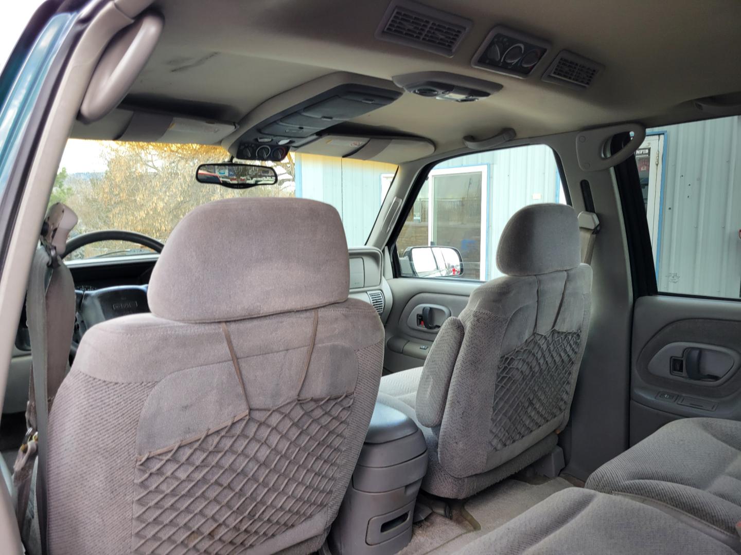 1998 Green /Gray GMC Suburban SLE (3GKFK16R9WG) with an 5.7L V8 engine, 4 Speed Auto transmission, located at 450 N Russell, Missoula, MT, 59801, (406) 543-6600, 46.874496, -114.017433 - 4WD SUV. 5.7L V8 Engine. 4 Speed Automatic Overdrive Transmission. Front and Rear Climate Control. AM FM CD Cassette. Air Cruise. Tilt. Power Front Seats. Power Windows and Locks. Towing. Running Boards. 3rd Row Seating. Because of the Age, financing is not available on this vehicle. - Photo#7